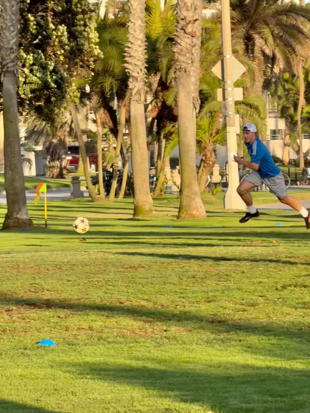 Player sprinting after the ball during training in a Santa Monica park